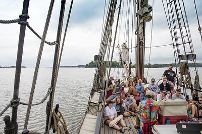 students on a historic sailboat, the sultana, listening to a lecture